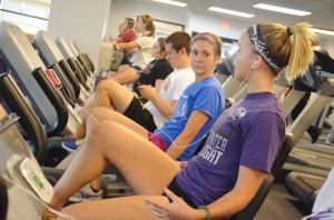 Liz Mielke and Mayzee Hurst talk and work out on the stationary bikes at the William Center.