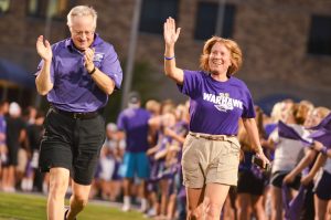 UW-Whitewater Chancellor Beverly Kopper and interim provost John Stone run through Perkins Stadium before students. Incoming freshman found themselves being swept up into their welcome activities after their arrival on campus on Sunday, August 30. Club U Dub Dub got students interacting with their peers and made them a part of the "Warhawk family" by participating in the R U Purple rally, running through Perkins Stadium and painting Warhawk Drive purple. They finished off the night by attending Club 1868. Photo by Aaron Gottschalk.