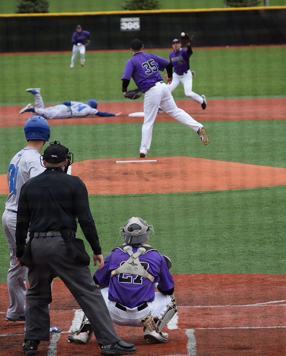 Junior catcher Brent Feldner looks on as freshman pitcher Brett Smerz attempts a pick-off play to senior second baseman Steve Chamberlain against Concordia University. UW-W fell 21-3. Photo by Hannah Jewell