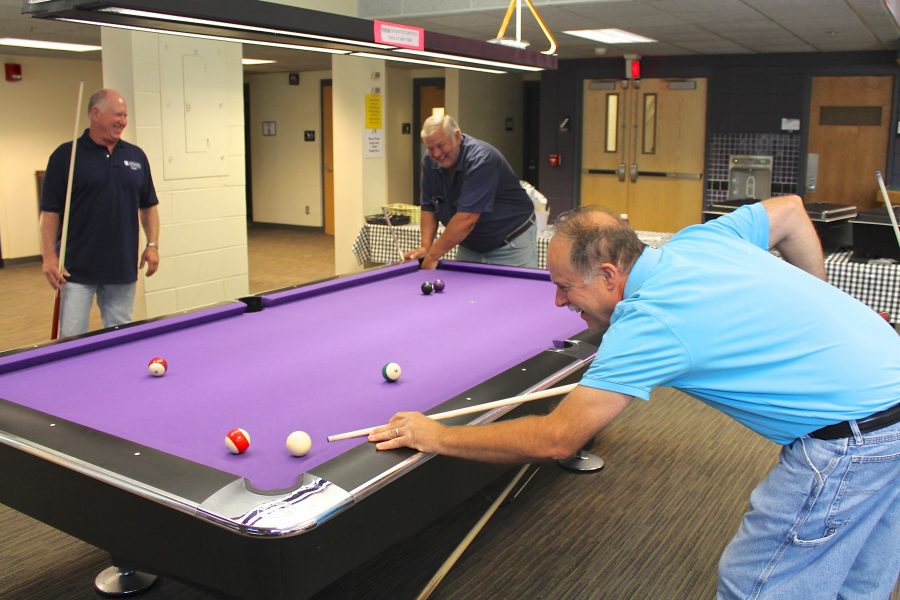 The billiards room in Warhawk Alley in the University Center was filled with custodians enjoying a break from work for a few hours before being served lunch.