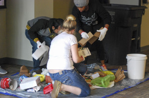 Students in attendance of Brent Flikkema’s presentation to promote the Reduce, Reuse and Recycle program, as part of the 2015 Sustainability Speaker Series that Resident Assistants were required to participate in as part of their training, put on their provided gloves and sorted through recycling.