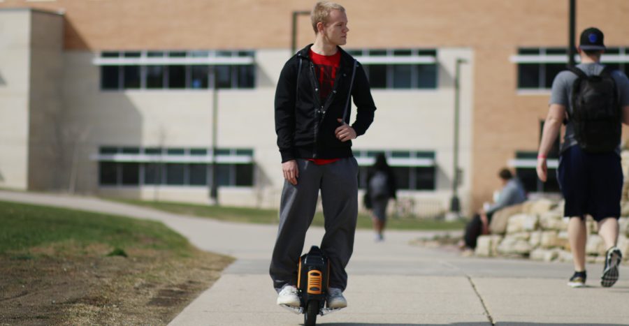 Junior Nathan Learned holds up his MonoRover, a one-wheeled electric scooter, that has gotten him a lot of attention. Various brands sell a similar device from the Airwheel to the Solowheel.
