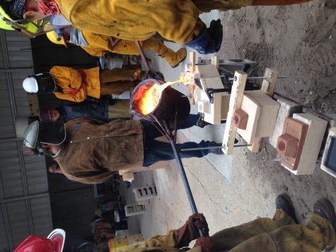 Hot iron poured into mold.