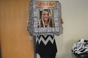 A jailbird holds up her “cell” while raising money for the Muscular Dystropy Association. Funds will go towards sending kids impacted by the disease to camp.