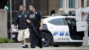 Dallas law enforcement patrols walk down the street a block from the police headquarters. Five members of law enforcement were killed at a Black Lives Matter protest following the deaths of two black men earlier that week. Photo courtesy of the Associated Press.