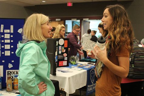 Kristin Wallace, Executive Director of Rock River Free Clinic, discusses student wellness with Cassie Benner, a representative for WellHawks at the Wellness Fair on Wednesday Oct 12. WellHawks is a student wellness organization on campus.  photo by Kim Gilliland