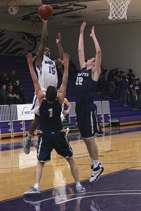 Junior guard Chris Jones shoots over defenders in a home game earlier this year.
