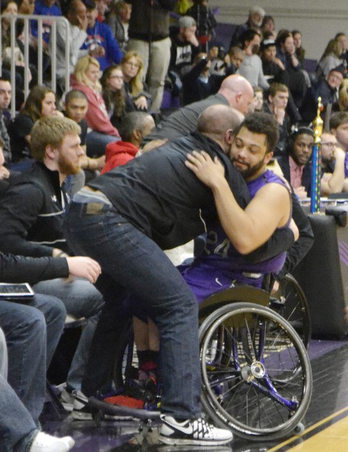 Senior Jordan Scheidecker hugs an assistant on the bench as he is subbed out for a final time as a Warhawk. Scheidecker is one of three ’Hawks graduating. Photo by Sierra High