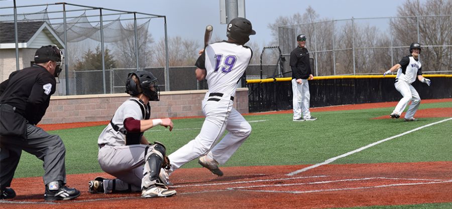 Junior outfielder Brett Krause begins running down the first base line after connecting on a hit as freshman outfielder Matt Wary rounds third base in an April 8 doubleheader vicotry vs. UW-La Crosse. The Warhawks have now won six straight. Photo by Hannah Jewell
