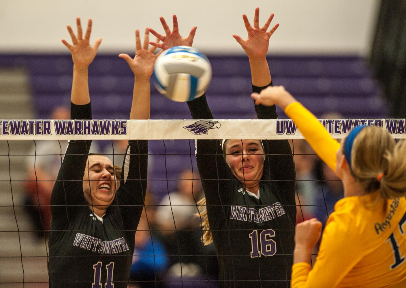 Senior middle hitter Courtney Wagner (11) and sophomore outside hitter Rachel Butterfield (16) team up for a block against Augustana. Wagner led the Warhawks with eight blocks and was one of two Warhawks to make the All-Tournament team. She was joined by junior libero Brittany Robinson