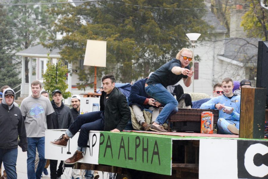 Brothers of the Pi Kappa Alpha fraternity interact with onlookers during the Homecoming parade. 
