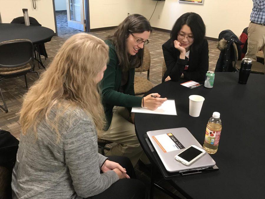Professors Yao Fu and Karla Saeger (left and far right) discuss their thoughts with librarian Diana Schull (center) after the GooseChase seminar