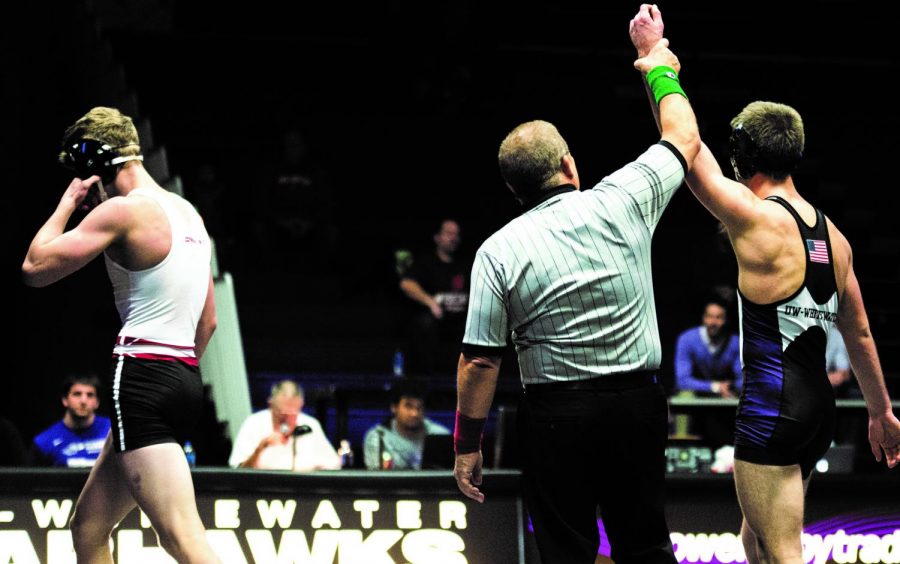 The referee raises sophomore Wilder Wichman’s hand after his 7-2 decision victory over the Badger’s Patrick Spray at 149 pounds. Wichman was
the only Warhawks’ wrestler to claim a victory in his match against the UW-Madison wrestling squad.