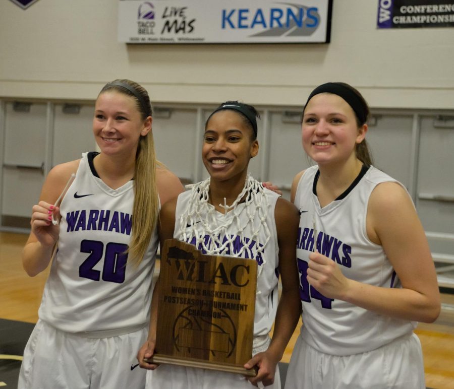 UW-Whitewater Warhawks Brooke Trewyn (left), Malia Smith (middle) and Andrea Meinert (right) hold the WIAC Trophy after defeating UW-Oshkosh 68-65 at Kechel Gymnasium on Feb. 24.