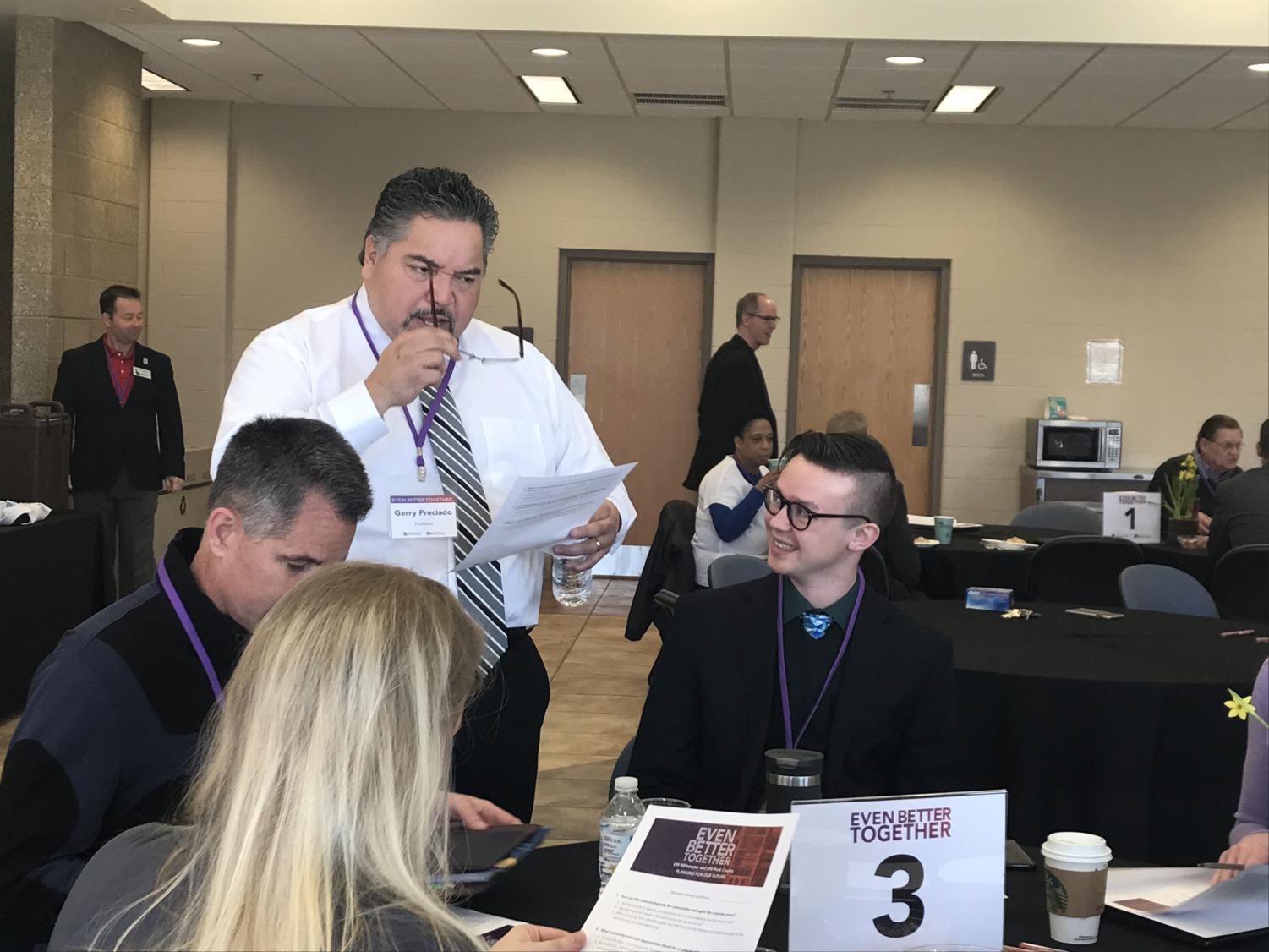Gerry Preciado leads a discussion about the UW-System merger with student body President Tom Kind and other attendees.