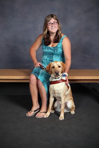 Elizabeth Fideler and her service dog, Victor, pose for a photo.