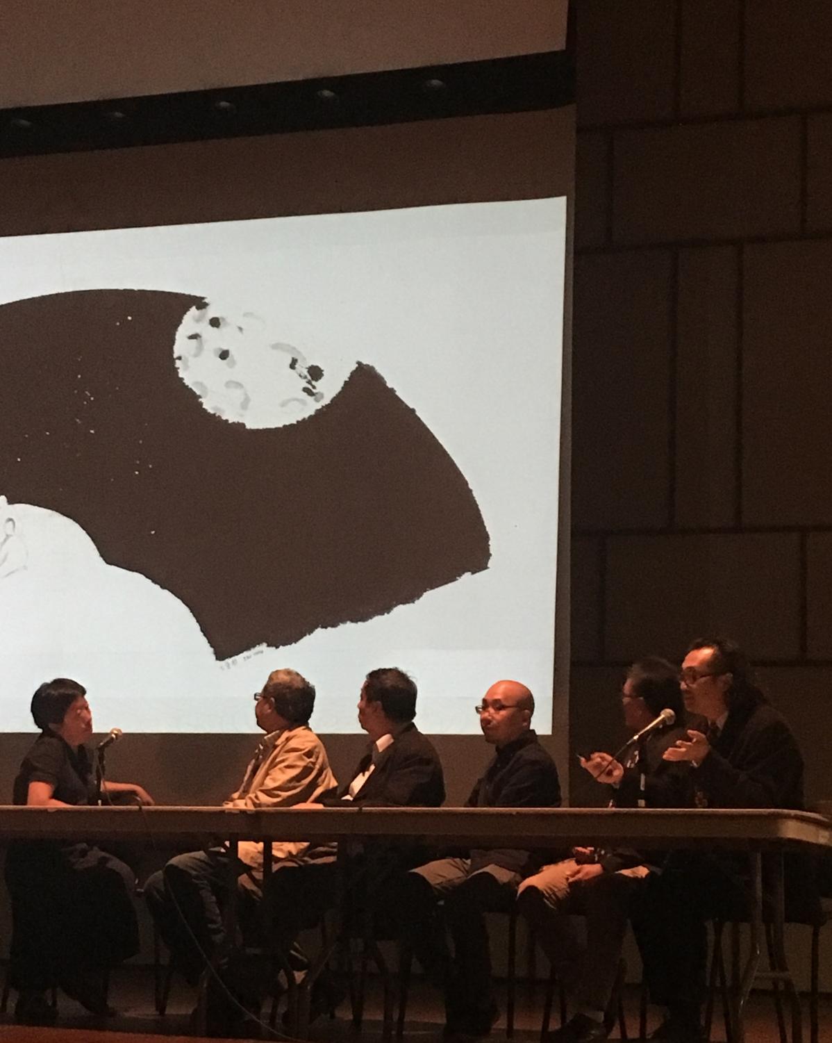 Art professor Wie Zhen discusses his ink painting that is about a variation of the Chinese story of seven artists with professors GuiSheng Wang, Zong Gu, Jiaduo Li and LInXia Jiang.