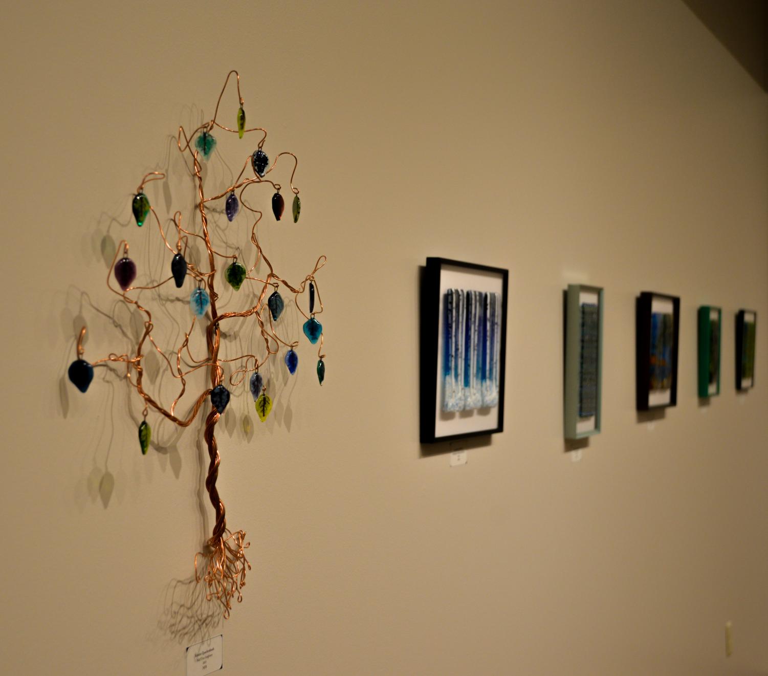 The current exhibit at Roberta’s Art Gallery features works by artist Kristin Quackenbush, who
utilizes different colors of broken glass to create visual depth in her pieces.