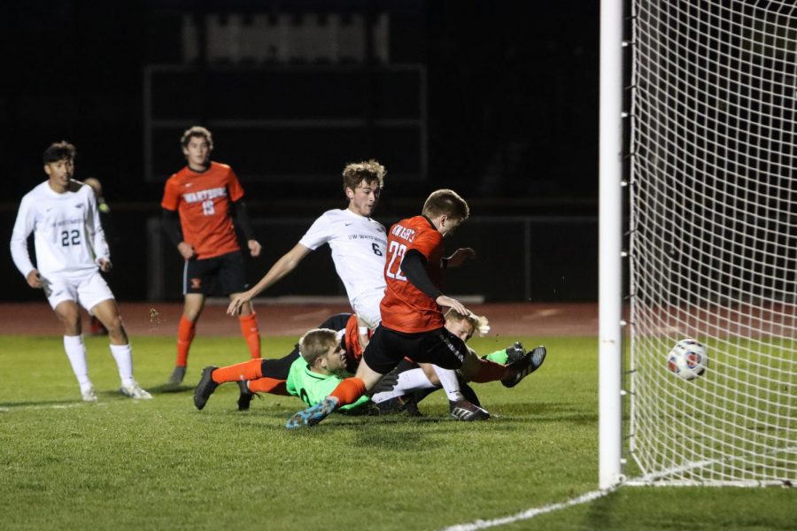 After a Goulmouth scramble, Mariano Carini puts the ball into the net for the Warhawks.
