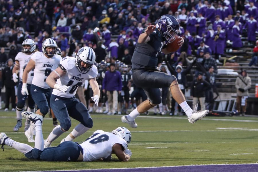 Junior+QB+Max+Meylor+hurdles+a+defender+on+his+way+to+the+endzone.+He+rushed+for+3+touchdowns+on+the+season%2C+including+the+final+score+against+UMHB+on+Saturday%2C+Dec.+7.+Meylor+has+also+thrown+for+800+yards+this+year.