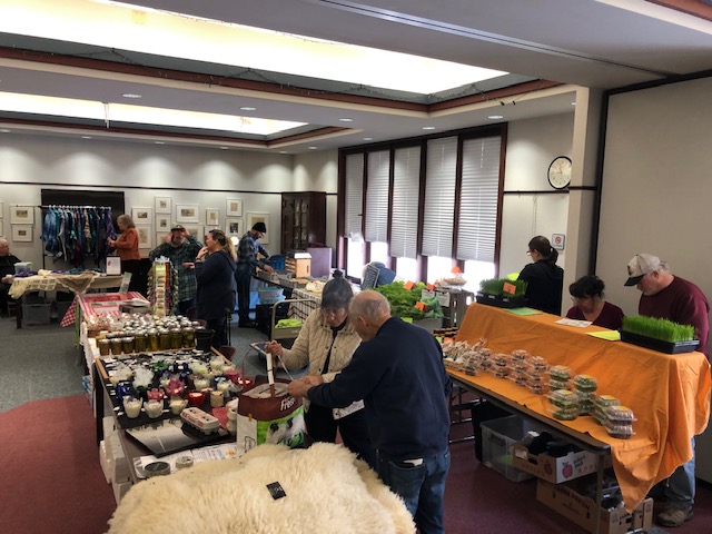 Whitewater City Market goers gather at the Irvin L. Young Library to purchase fresh produce like late season lettuce and dry goods for the winter season.