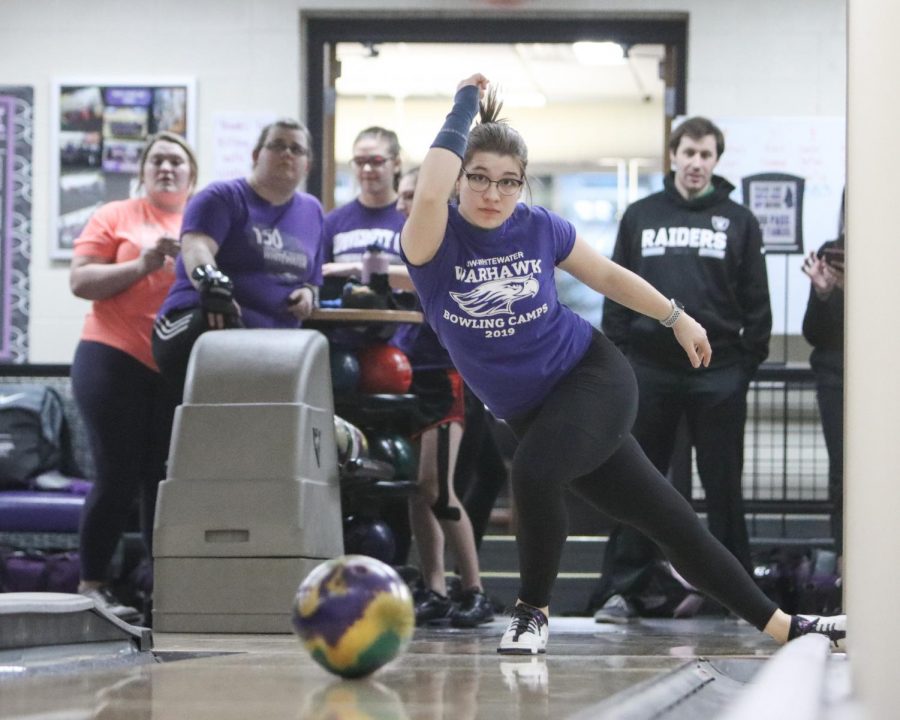 Piper Miles rolls her ball down Warhawk Alley in front of teammates during practice for the Dec. 7 event.