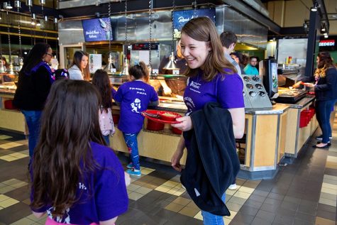 Students and Little Scholars enjoy a meal together during a bonding program put on by the organization at Esker Dining Hall.