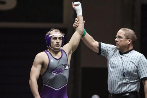 Senior Mike Tortorice has his hand raised in victory after a previous match this season. The senior was headed to the national tournament before it was cut short.