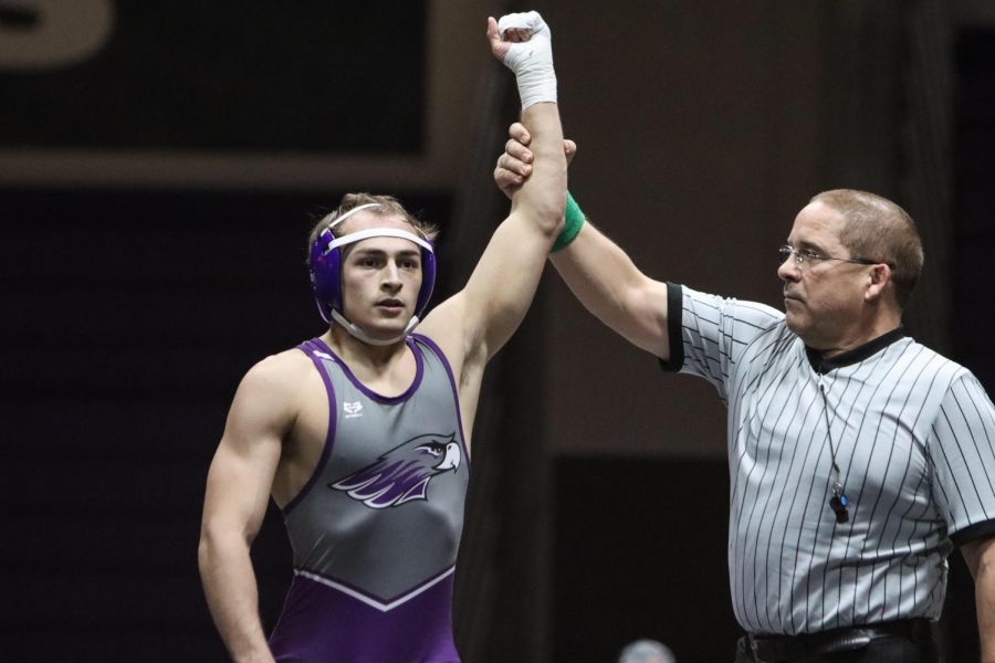 Senior Mike Tortorice has his hand raised in victory after a previous match this season. The senior was headed to the national tournament before it was cut short. 