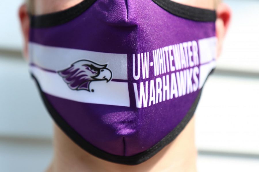 Photographer Dane Sheehan takes a self portrait wearing the new UW-Whitewater Warhawks mask. 