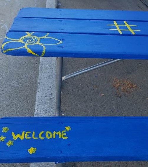 Volunteers paint picnic tables for a new outdoor eating area in downtown Whitewater open through Oct. 31. 