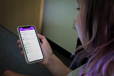 Student Sarah Augustine checks out the UW-Whitewater Mobile App while relaxing in her residence hall.