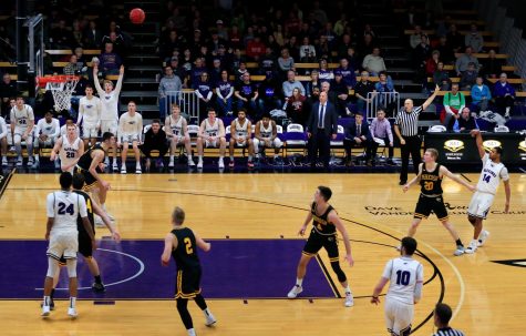 Senior guard Andre Brown (14) makes a three-point shot late in the second half to bring the Warhawks within one point of UW-Oshkosh in a WIAC conference game at the Williams Center on Wednesday, January 16, 2019. The Warhawks could not overcome the No. 5 Titans but Brown in the first half became the 29th player in program history to reach 1,000 career points.