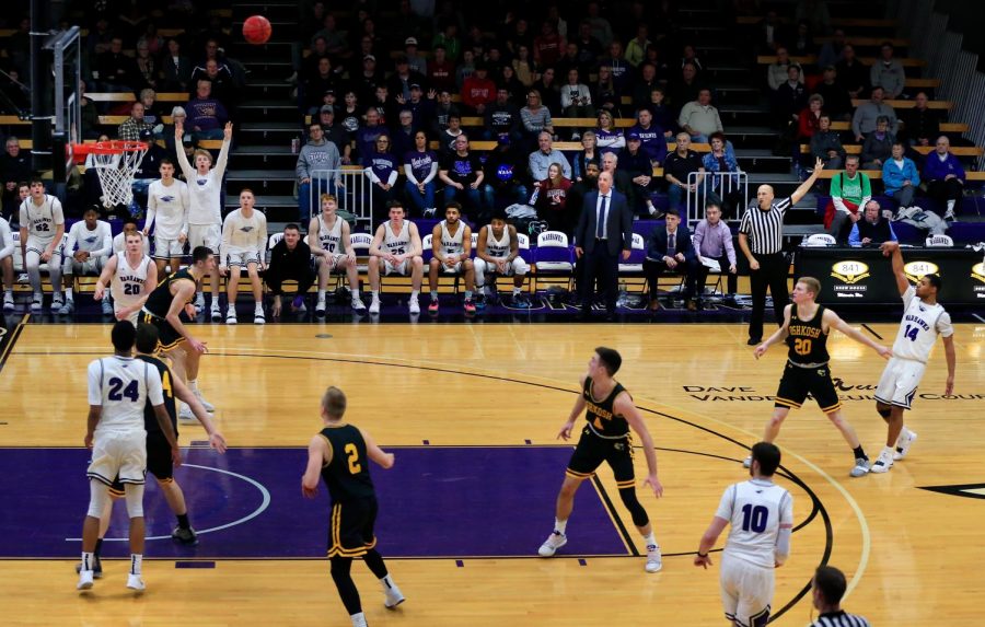 Senior guard Andre Brown (14) makes a three-point shot late in the second half to bring the Warhawks within one point of UW-Oshkosh in a WIAC conference game at the Williams Center on Wednesday, January 16, 2019.  The Warhawks could not overcome the No. 5 Titans but Brown in the first half became the 29th player in program history to reach 1,000 career points. 