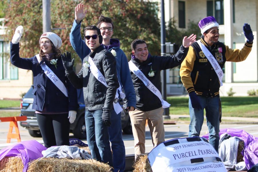 The+2019+Homecoming+Court+waves+to+the+crowd+from+a+float+in+the+annual+parade.+