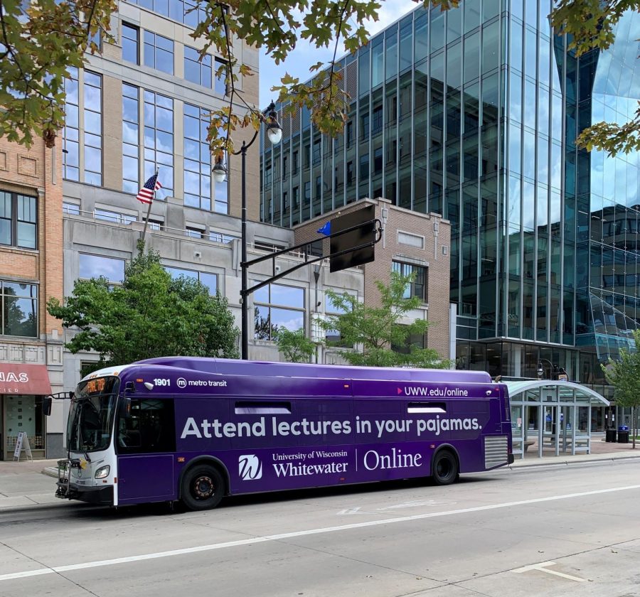 A city bus makes a stop on the capitol square in Madison advertising online classes at UW-Whitewater.