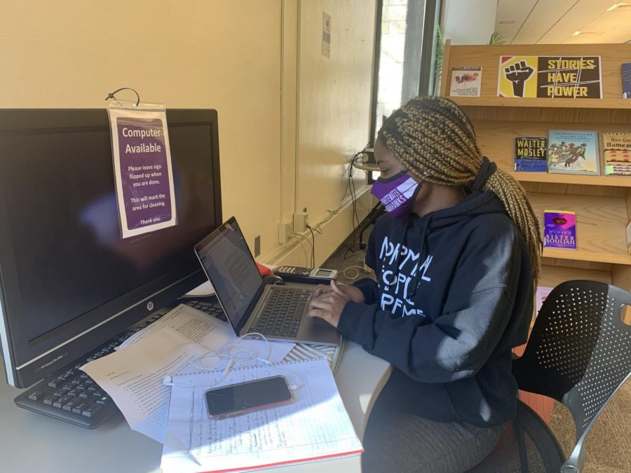 Freshman Biology Major Cleopatra Achemsa is utilizing the peaceful library space to write her upcoming English paper.