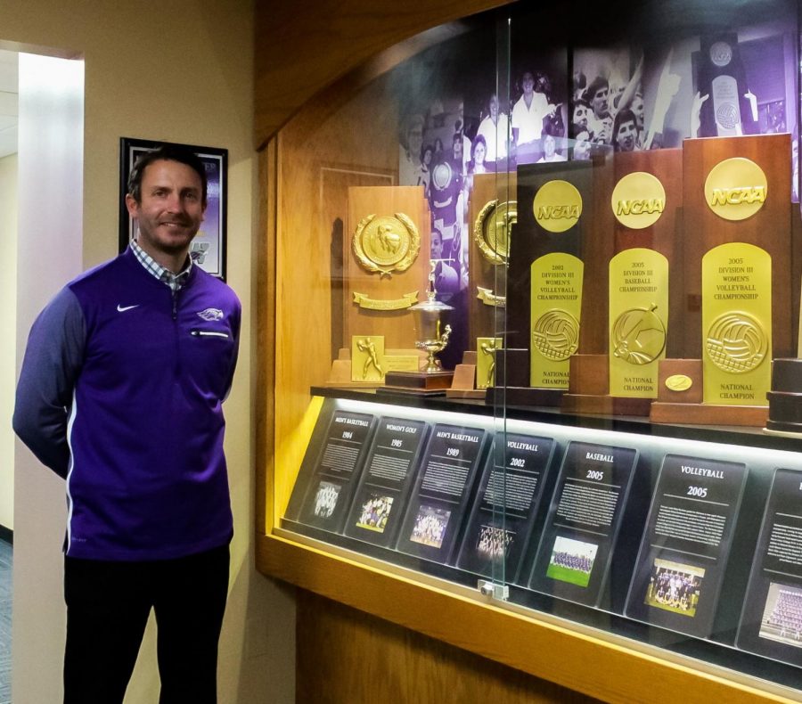 Standing next to the many women’s championship trophies, Interim Director of Intercollegiate Athletics Ryan Callahan proudly celebrates 50 years of the Wisconsin Women’s Intercollegiate Athletic Conference in the Williams Center Oct. 23. 