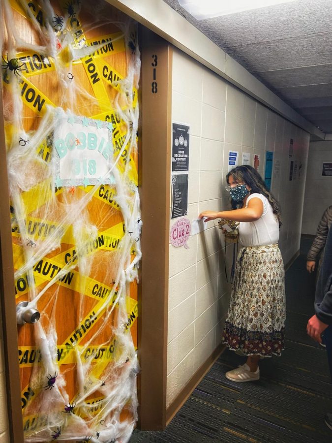 Alexa (pictured above) finds a clue within an envelope located in Knilans Hall for the Wellers & Knilans LIT Halloween Scavenger Hunt on Friday October 23.