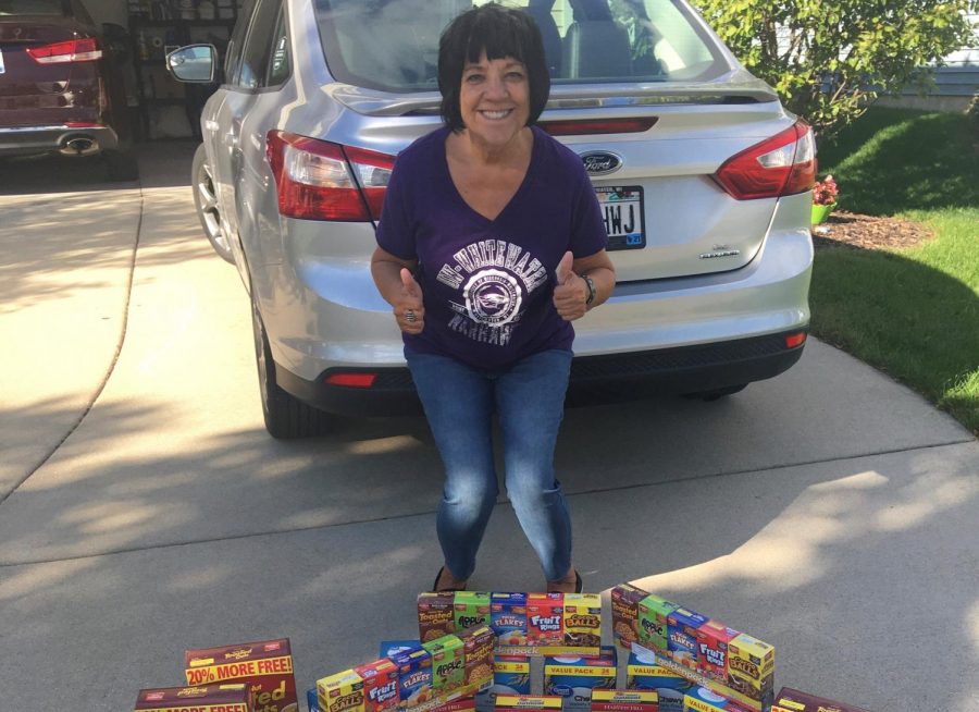 Communication associate professor Kate Ksobiech begins loading a pile of donations for students quarantined in Clem Hall. 