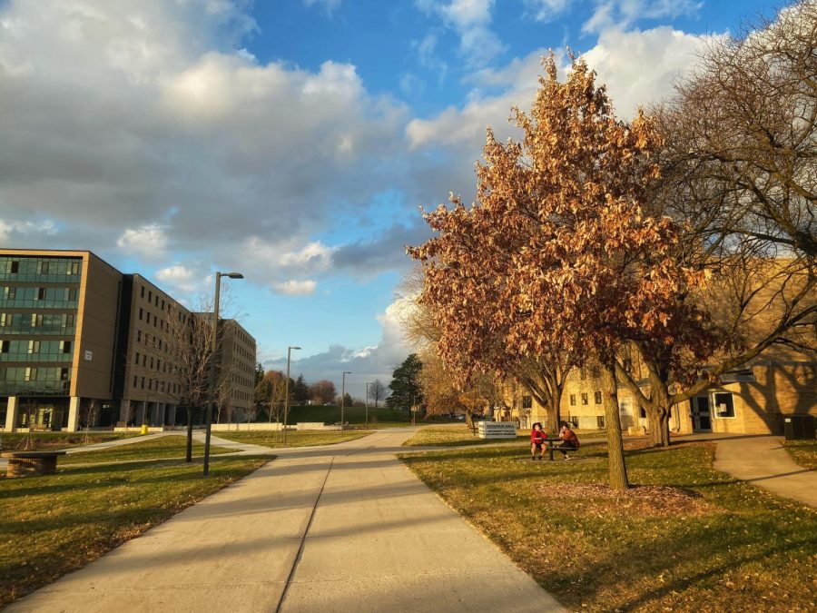 UW-W students sit on the benches outside of Goodhue Hall enjoying the fall weather Nov. 14.