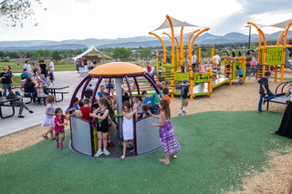 Children play on a We-Go-Round wheelchair accessible merry-go-round that will be placed in Starin Park as a part of the all-inclusive playground equipment efforts.