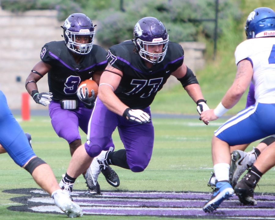 University of Wisconsin-Whitewater football offensive lineman Quinn Meinerz (77) prepares to
set a block for running back Jarrod Ware (9), during a game between UW-Whitewater and
Dubuque (Iowa) in September 2019.