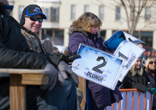 UW-Whitewater police chief Matt Kiederlen, left, and Therese Kennedy of recreational sports and facilities, judge contestants plunging style.  Also judging was Athletic Director Todd Garzarelli. The Whitewater Polar Plunge fundraiser for the Special Olympics of Wisconsin was held on Saturday, February 10, 2018 at Cravath Lake Park in Whitewater. (UW-Whitewater photo/Photo/Craig Schreiner)