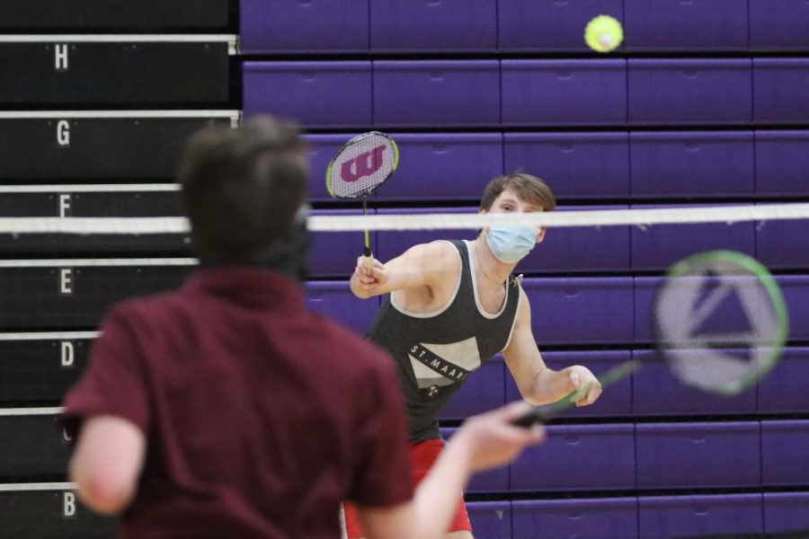 Freshman Colin Anderson watches the shuttlecock fly over the net while competing in the
badminton club doubles tournament final, Tuesday March 16.