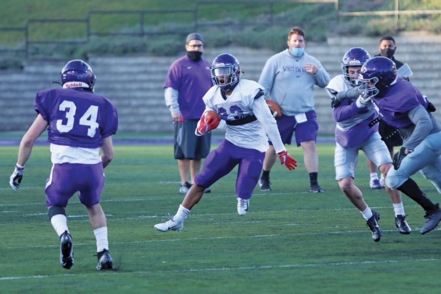 Senior running back Alex Peete (23) makes a move on a defender while running the ball, during a morning practice in November 2020 at Perkins Stadium. 