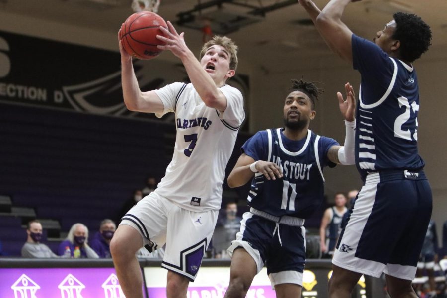 Sophomore guard Gage Malensek (3) drives to the basket during a regular season game between the warhawks and UW-Stout on wednesday Feb. 24. 