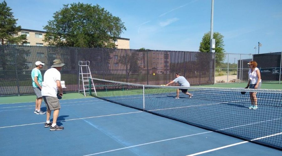 Organizational members stay active by playing pickleball out in the sunshine on a warm Wisconsin day. 