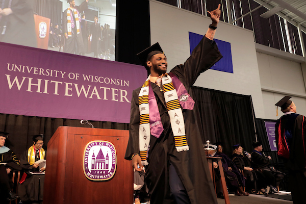 Leonard Brox, a liberal studies graduate from Milwaukee, salutes the crowd as he crosses the stage at UW-Whitewaters commencement Saturday, May 18, 2019, in Kachel Fieldhouse.
(UW-Whitewater photo/Andy Manis)