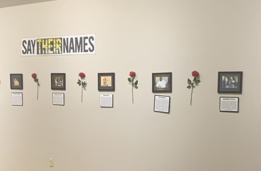 Wall of framed pictures in the Say Their Names exhibit